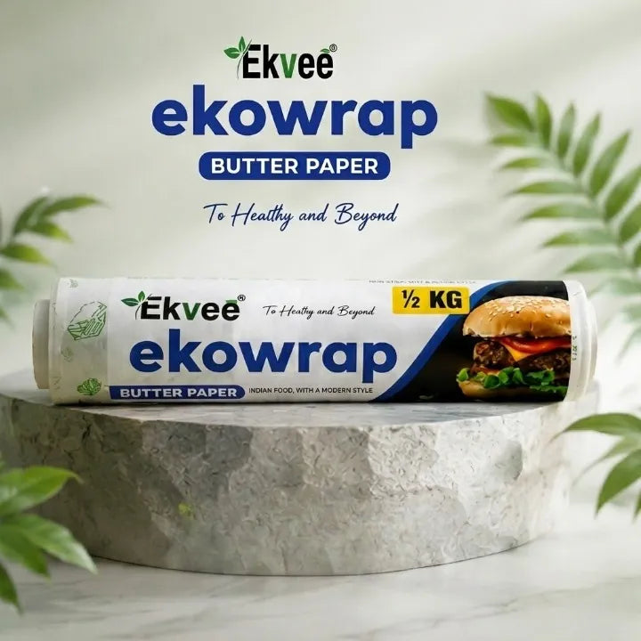 Ekvee Ekowrap butter paper ½ kg roll displayed on a pedestal, with packaging featuring a burger image and the tagline “To Healthy and Beyond.”