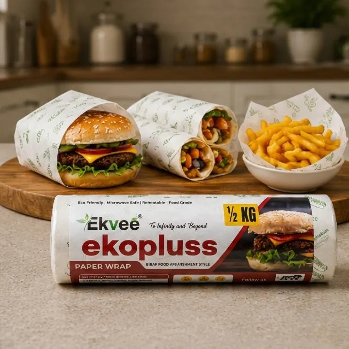 A roll of Ekvee Ekopluss paper food wrap is shown in the foreground, with three wrapped burgers, a side of fries, and the wrapped wrap rolls styled on a wooden board in a kitchen setting.