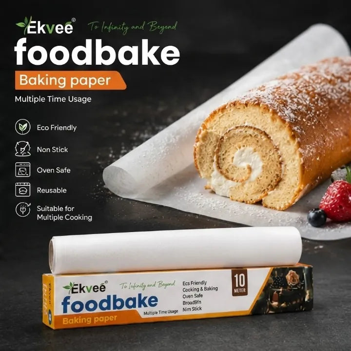 Ekvee foodbake baking paper 10 meter roll with its retail box, shown next to a sliced cake roll on parchment paper against a dark background.